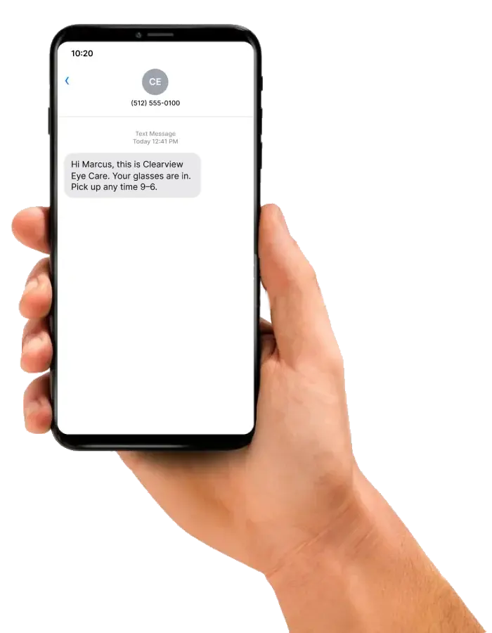 A hand holding a phone with a text from Clearview Eye Care: your glasses are in